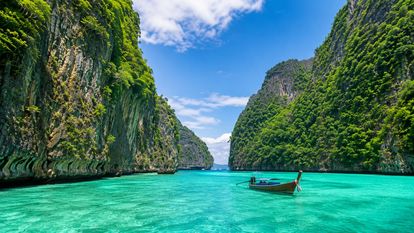 Phuket beach in Thailand with blue sea and boats