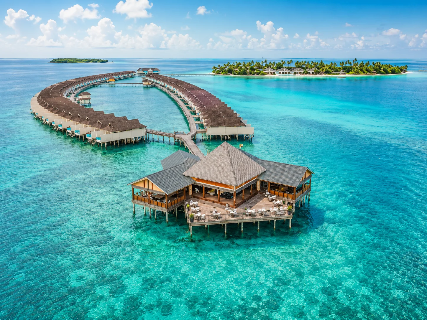 Maldives beach with overwater villas and clear blue water